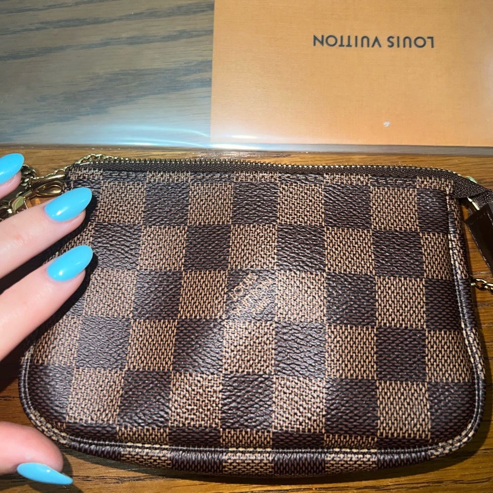 Authentic Louis Vuitton pochette accessory.